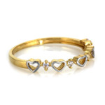 Złoty pierścionek 585 z dwukolorowych serc z cyrkoniami 1,18g